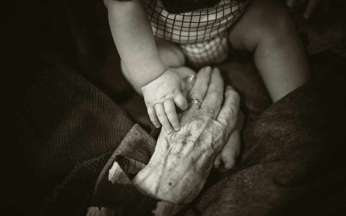 Child touches grandmother (Rod Long)